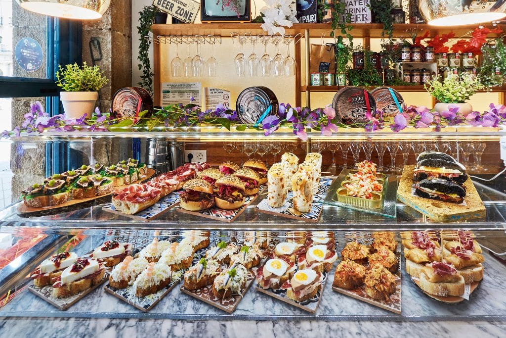 A picture of an array of pintxos in Bilbao! Bilbao is worth visiting to try the flavorful pintxos that the region is so famous for.