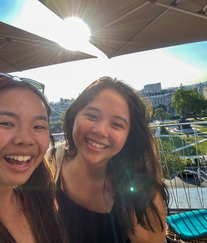 A picture of Kristin and her friend on top of the rooftop of the People Hostel Paris