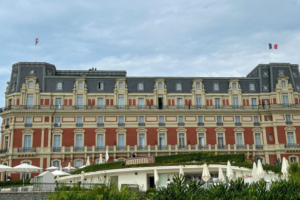 A picture of the 5-star Hôtel du Palais in Biarritz. It is located right on the beach and even has security at the entrance.