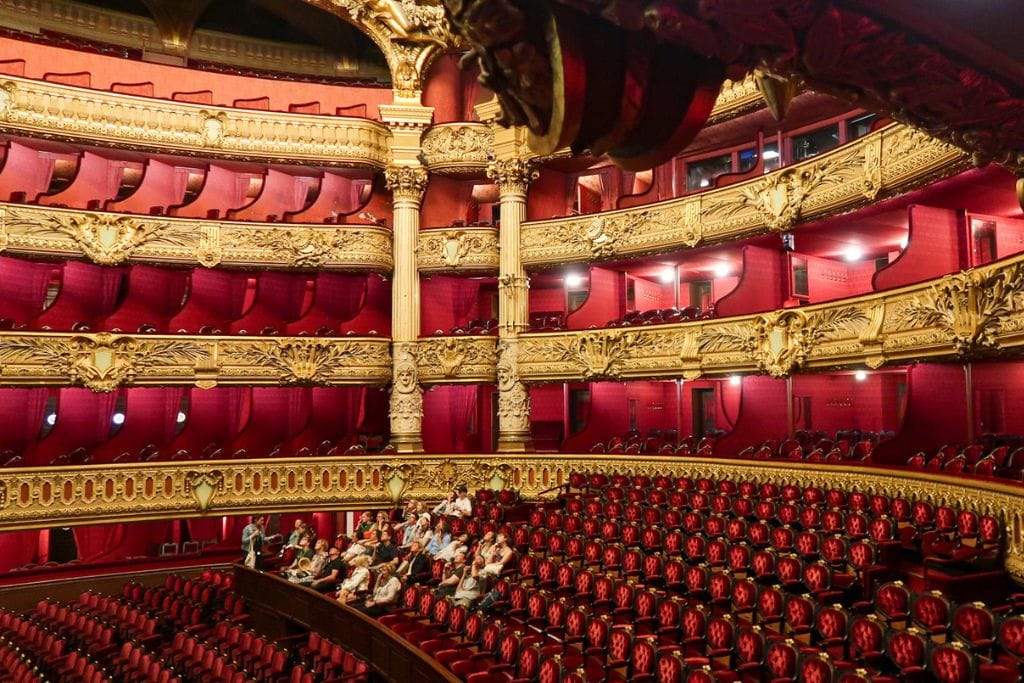 A picture of the main stage auditorium. Getting to see the red velvet seats, contrasted by the beautiful gold gilding makes the Palais Garnier worth visiting!