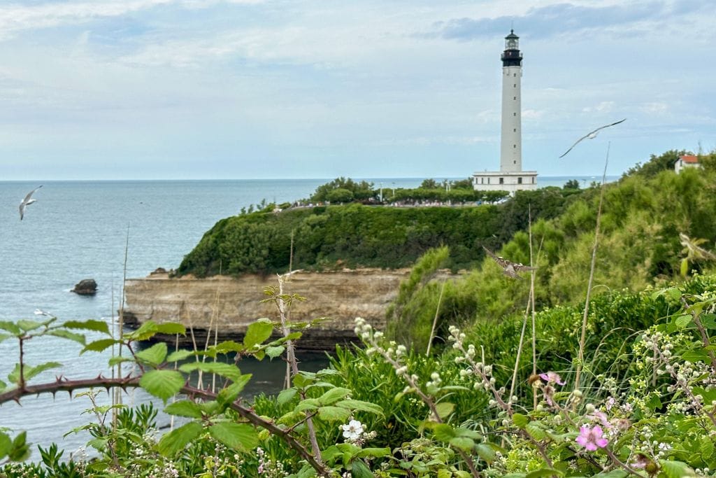 A picture of the Biarritz Lighthouse standing tall over the coastline.