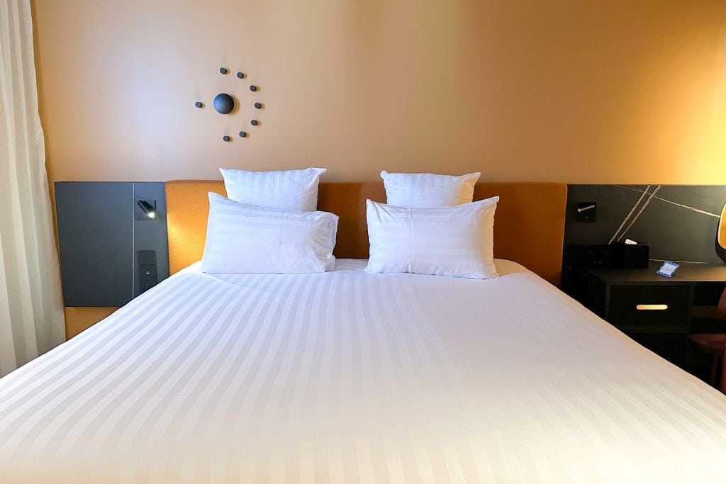 A picture of the large bed that is provided in the double rooms at Tribe Hotel Paris Saint Ouen.