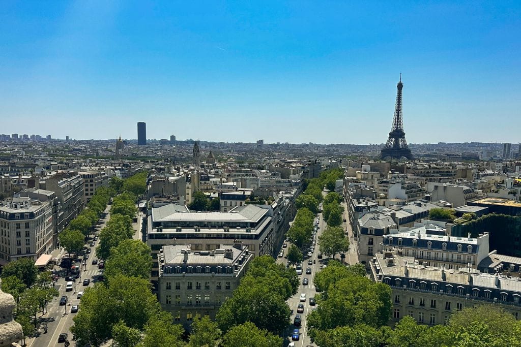A picture of the Paris cityscape and Eiffel Tower as seen from the top of the Arc de Triomphe.