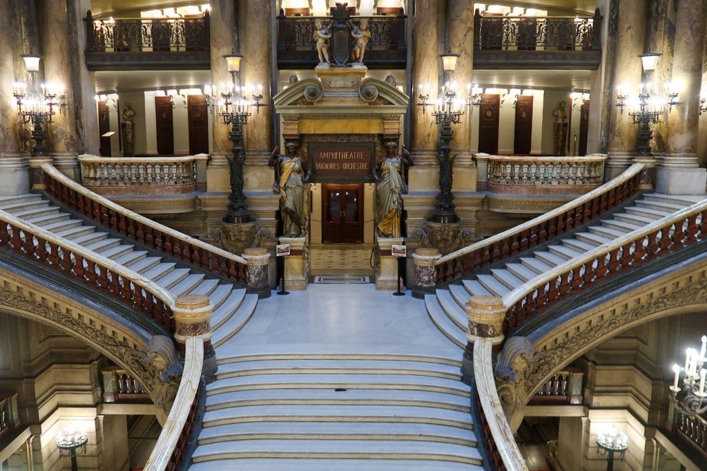 A picture of the grand staircase in the Palais Garnier. You can see the two upper level staircases as they diverge.