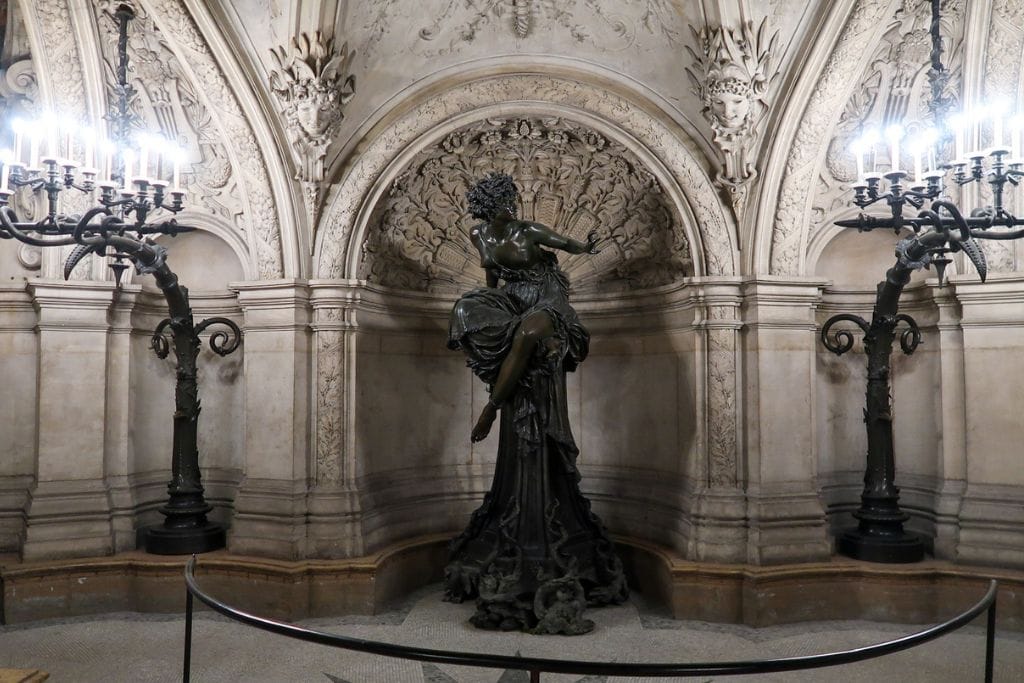 A picture of the famous statue at the base of the grand staircase. Uncovering the secrets and understanding the meaning behind the art displayed is another reason to make a point of visiting the Palais Garnier.