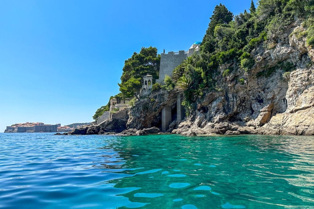 A picture of the clear blue-turquoise waters and some ancient structures you'll pass by on many of the Dubrovnik kayak tours.