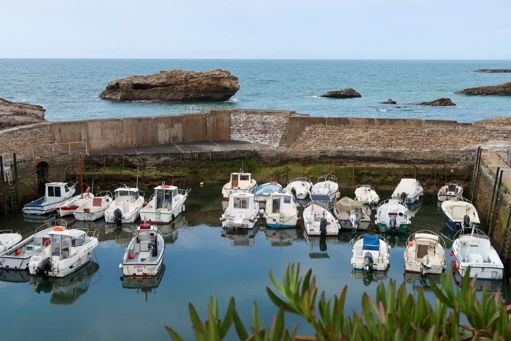 A picture of numerous little boats docked in Le Port des Pêcheurs.
