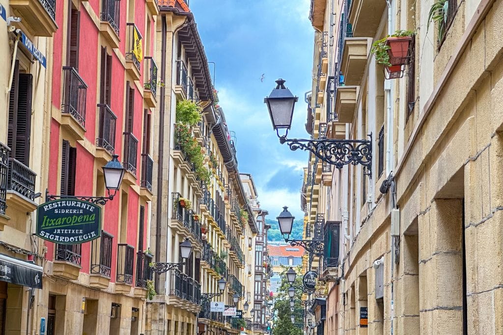 A picture of a colorful and bustling alleyway in San Sebastian's Old Town.