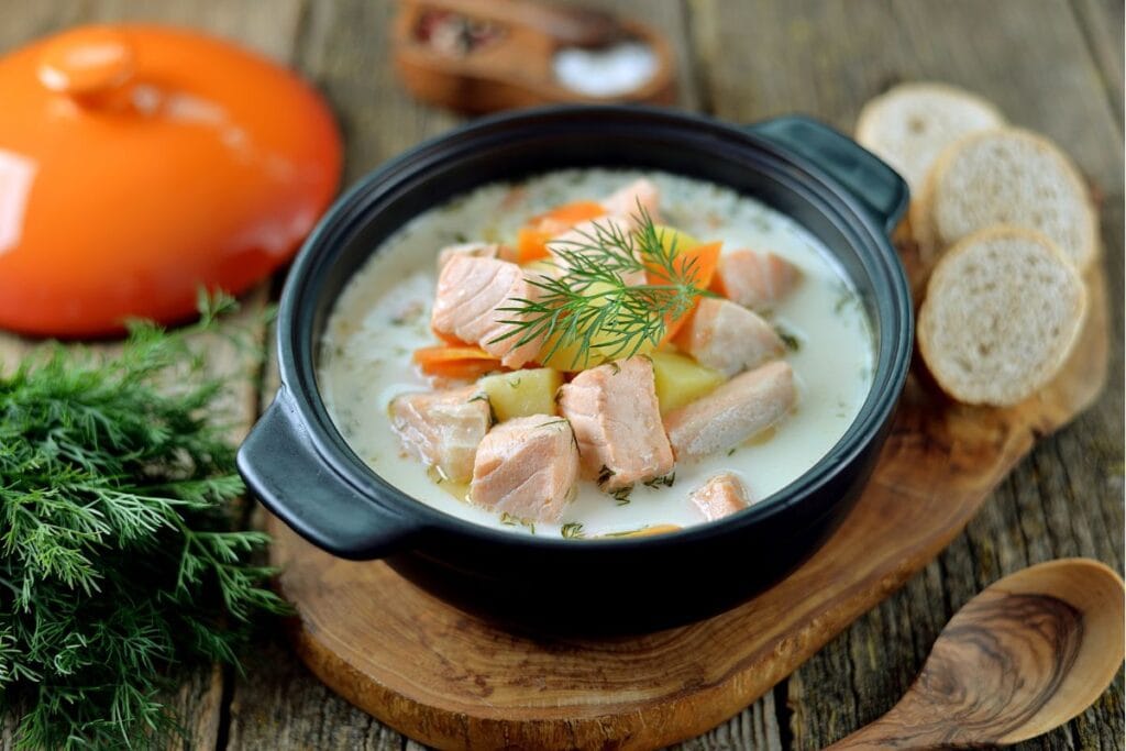 A picture of a bowl of traditional Finnish salmon soup. While you might not get to taste this one your food tour in Helsinki, be sure to order it on your own time before you go! It's a staple in their local diet.