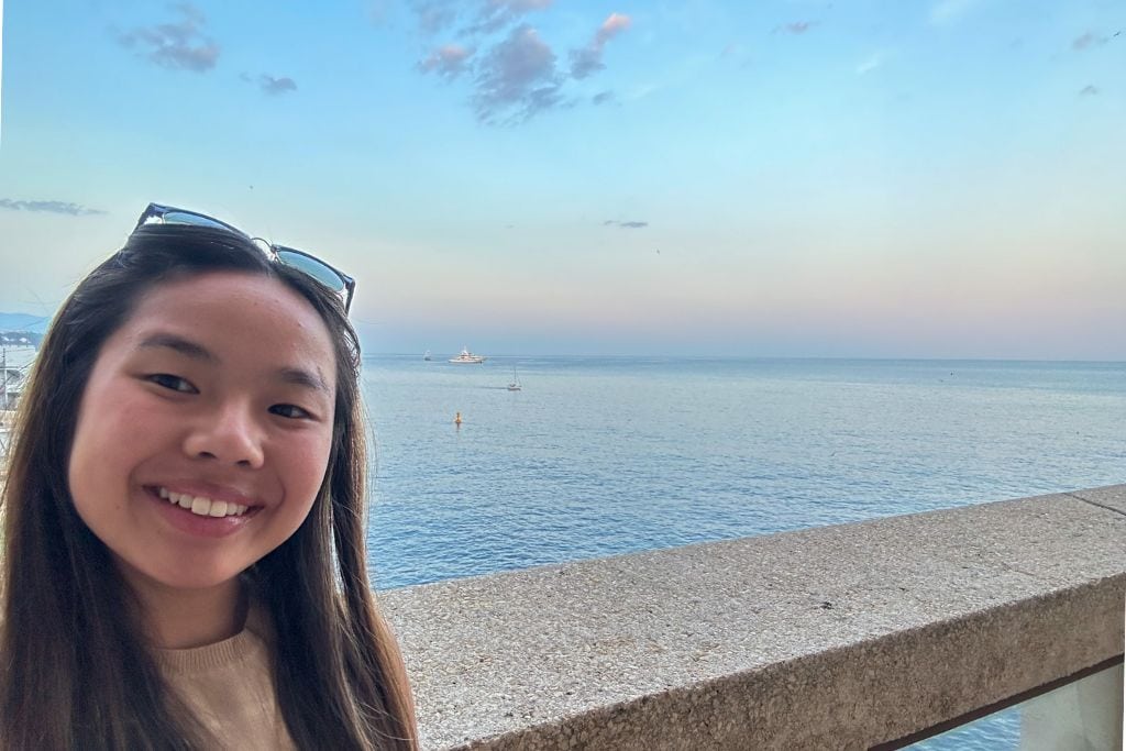 A selfie of Kristin enjoying the sunset from her room at the Fairmont in Monaco.