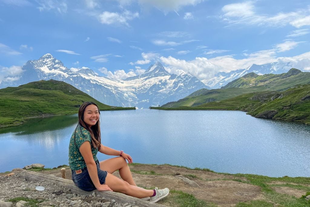 A picture of Kristin sitting next to Lake Bachalpsee. If you like hiking, Grindelwald is likely worth visiting since the area is packed with different scenic hikes.