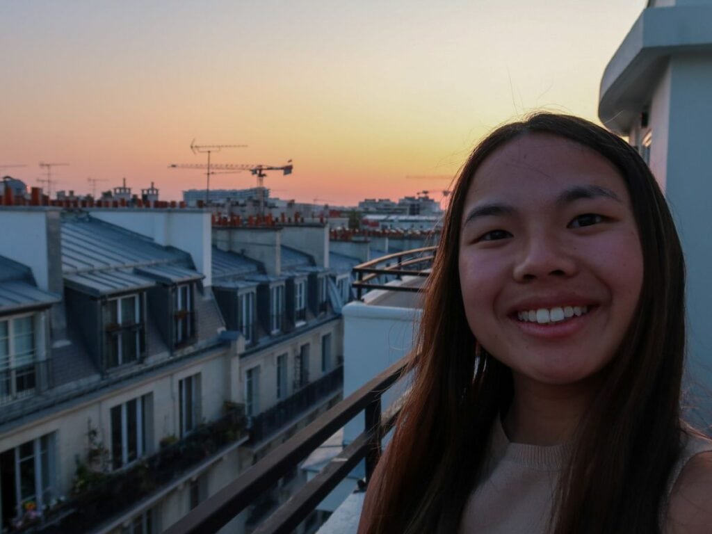 A picture of Kristin smiling from her hotel room balcony!