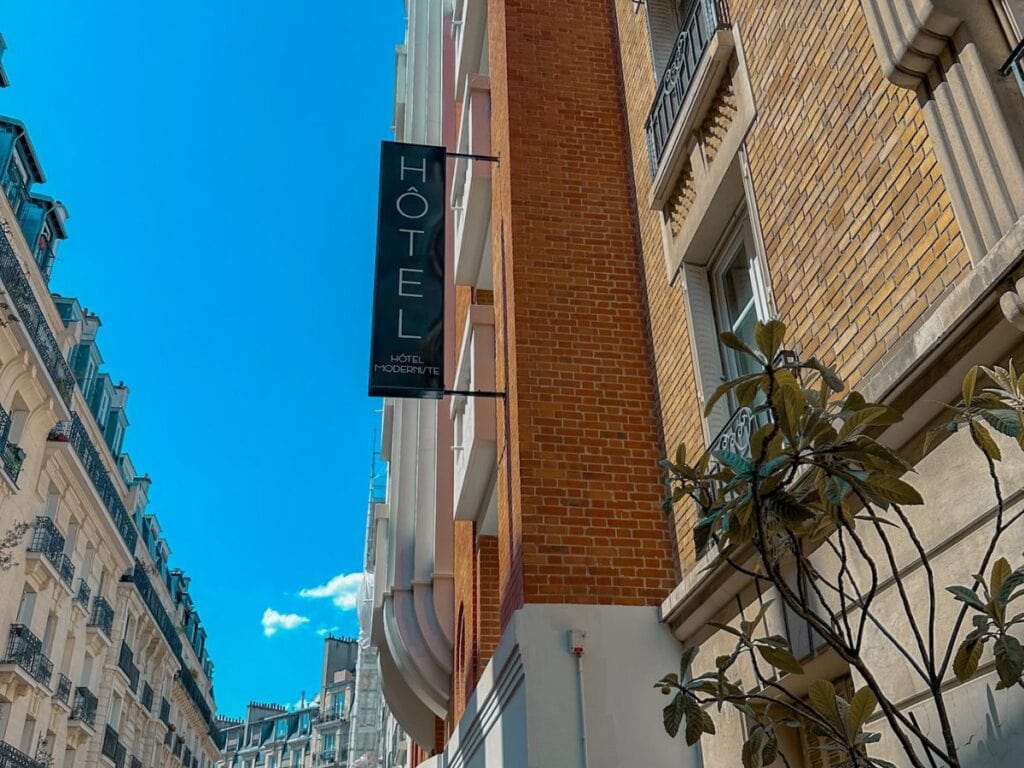 A picture of the Hotel Moderniste's sign from the streets of Paris.