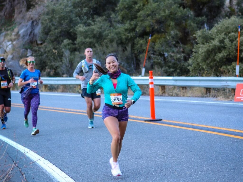 A picture of Kristin smiling while running the Revel Big Bear Marathon.