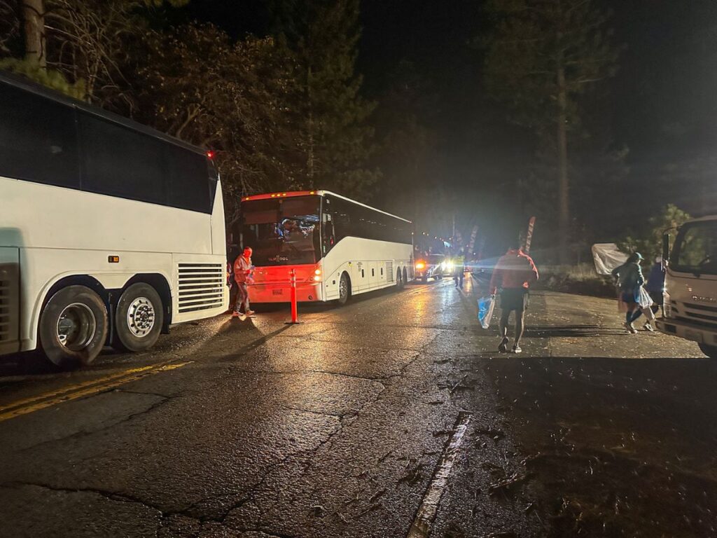 A picture of buses that are dropping off runners at the start area for the Revel Big Bear Marathon.