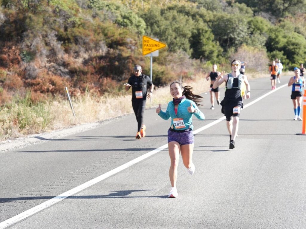 A picture of Kristin running downhill during the Revel Big Bear Marathon.