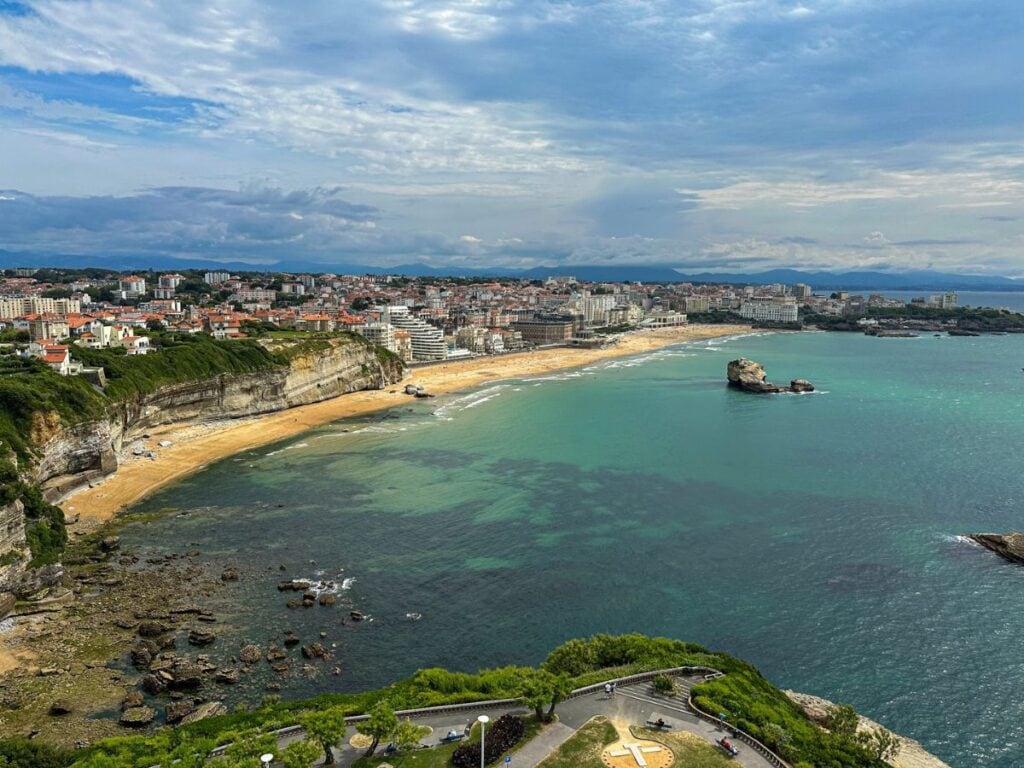 A picture of bright and sunny coastline from the top of Phare de Biarritz