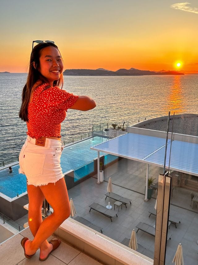 A picture of Kristin admiring the sunset over the water from her hotel in Dubrovnik.