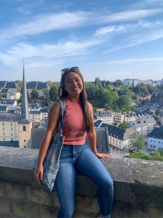 A picture of Kristin sitting on the wall at Chemin Corniche in Luxembourg City