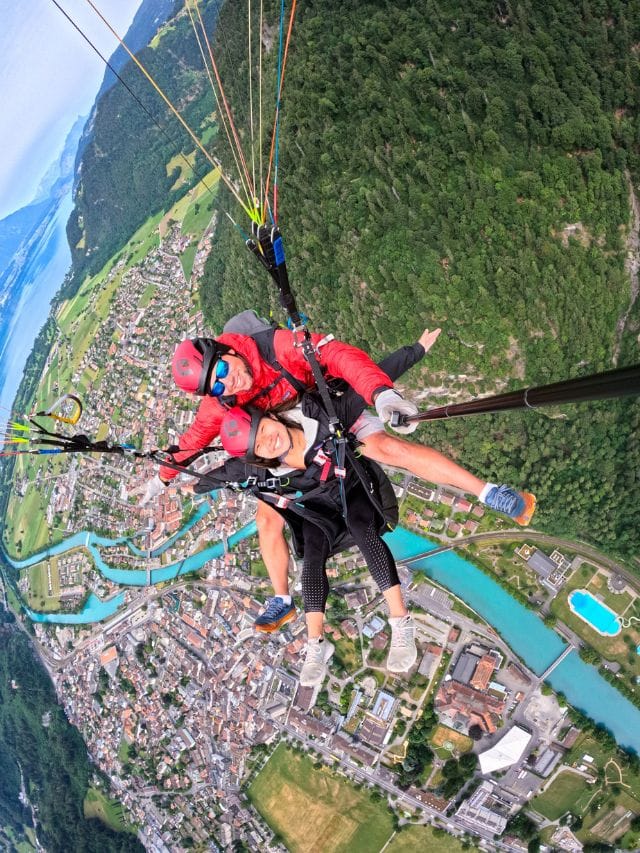 A picture of Kristin paragliding over Interlaken in Switzerland.