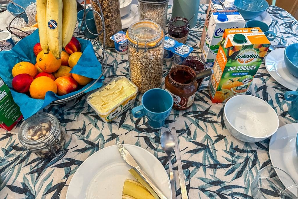 A picture of apples, bananas, granola, yogurt, and spreads available at breakfast.