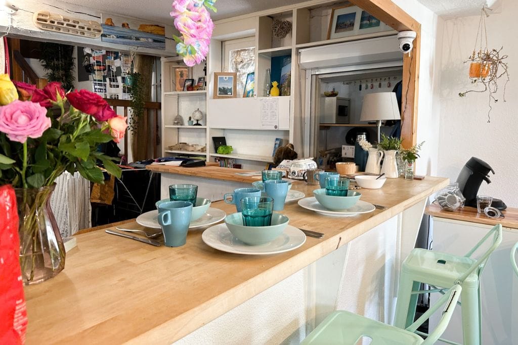 A picture of the breakfast set up in the kitchen area. All the plates and cutlery are laid out.