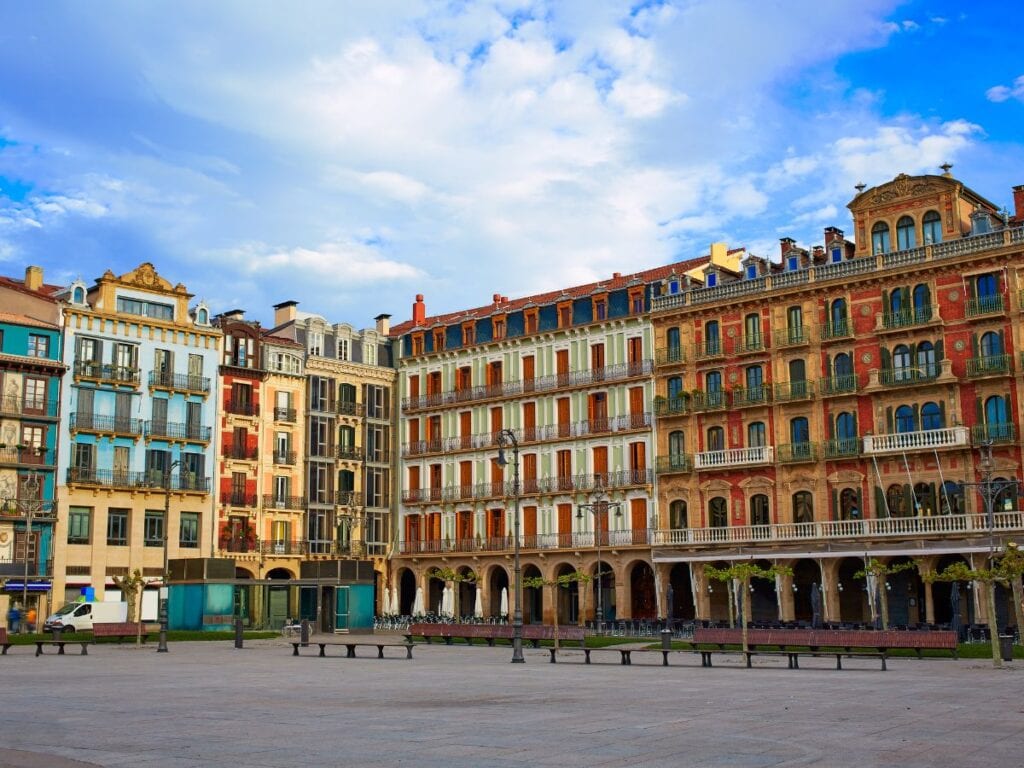 A picture of all the vibrantly colored buildings in Plaza del Castillo in Pamplona.