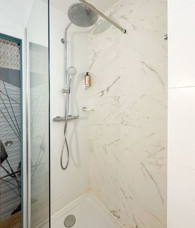 A picture of the bathroom in my room at the hotel. Make note of the shower door that doesn't extend all the way across.