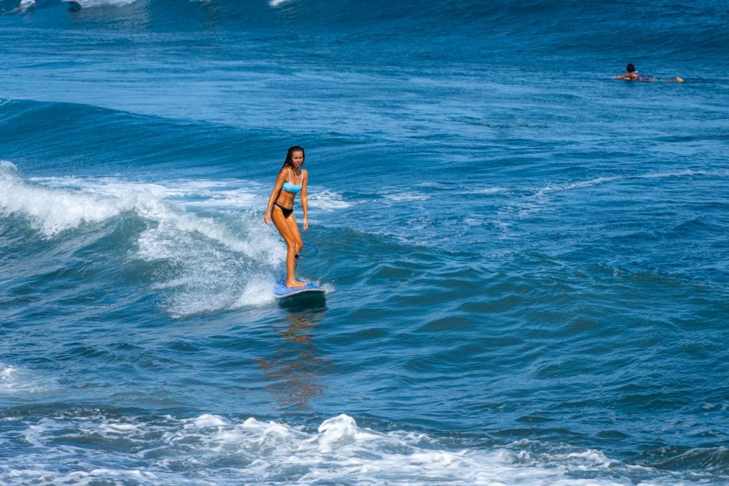 A picture of a girl surfing at Papara. Surfing is a favorite pastime for locals in Tahiti. 