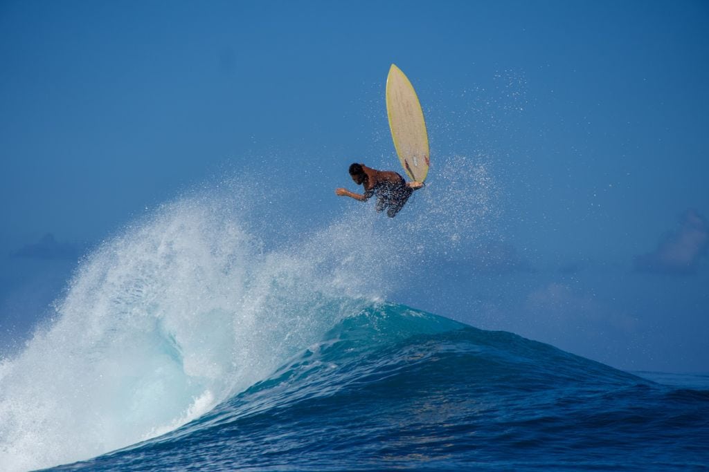 A picture of a local surfer after exiting Teahupoo's barrel.