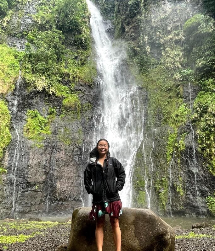 A picture of Kristin standing in front of waterfall in Tahiti!