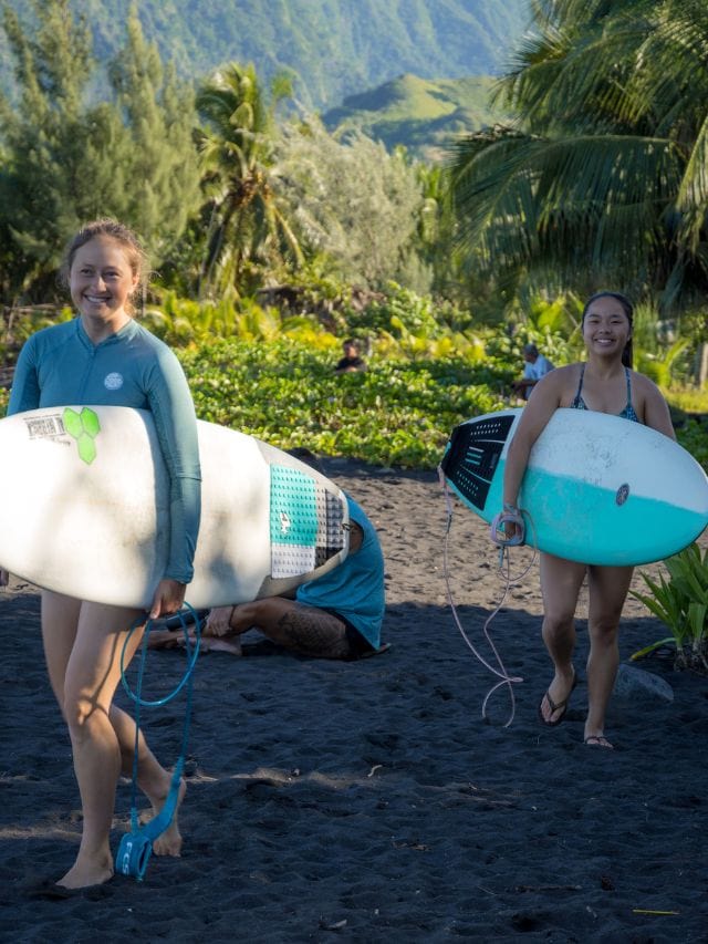 Kristin and her friend heading out to surf at Papara. If you plan on surfing during your time in Tahiti, don't forget to bring surf wax meant for warm tropical waters.