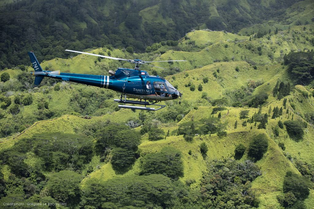 A picture of a Tahiti Nui Helicopter flying over Tahiti.