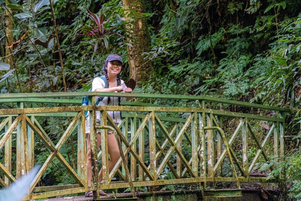 A picture of Kristin standing on a bridge in Fautaua Valley in Tahiti.