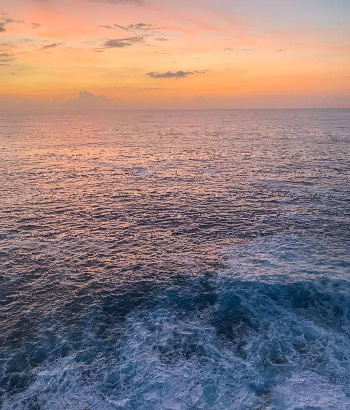 A picture of the sunset over the water as seen from a sunset cruise