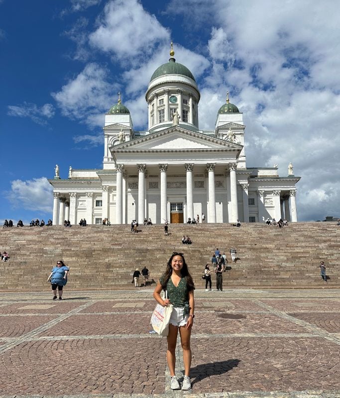 A picture of Kristin standing in front of the Helsinki Cathedral, which you will likely pass on your Helsinki Food tour or while you're walking around the city.