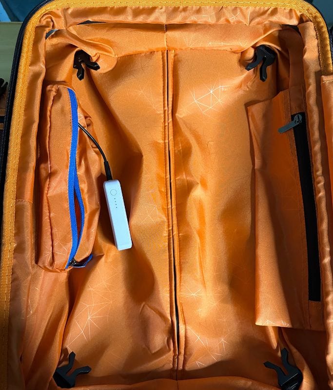 A picture of the left side compartment of the Silverwood II carry on suitcase. You can see the two pockets on the inside. One pocket is for your portable battery.