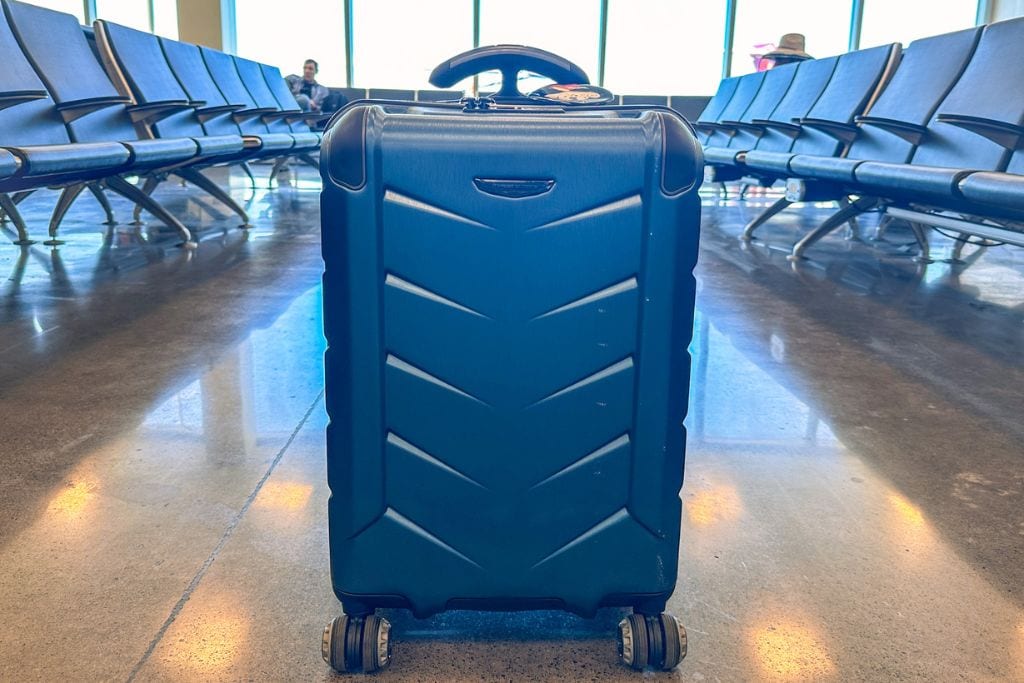 A picture of a navy blue Silverwood II carry-on suitcase by Travelers Choice at the airport.