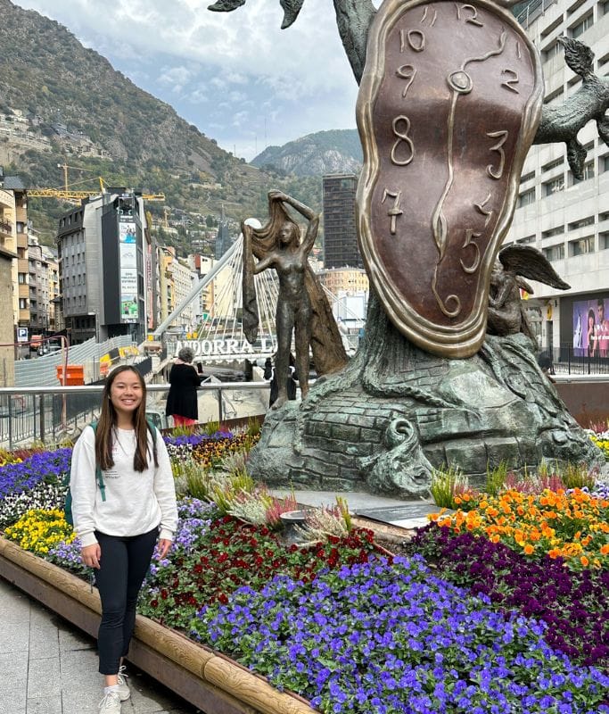 A picture of Kristin standing next to an art installation in Andorra la Vella.