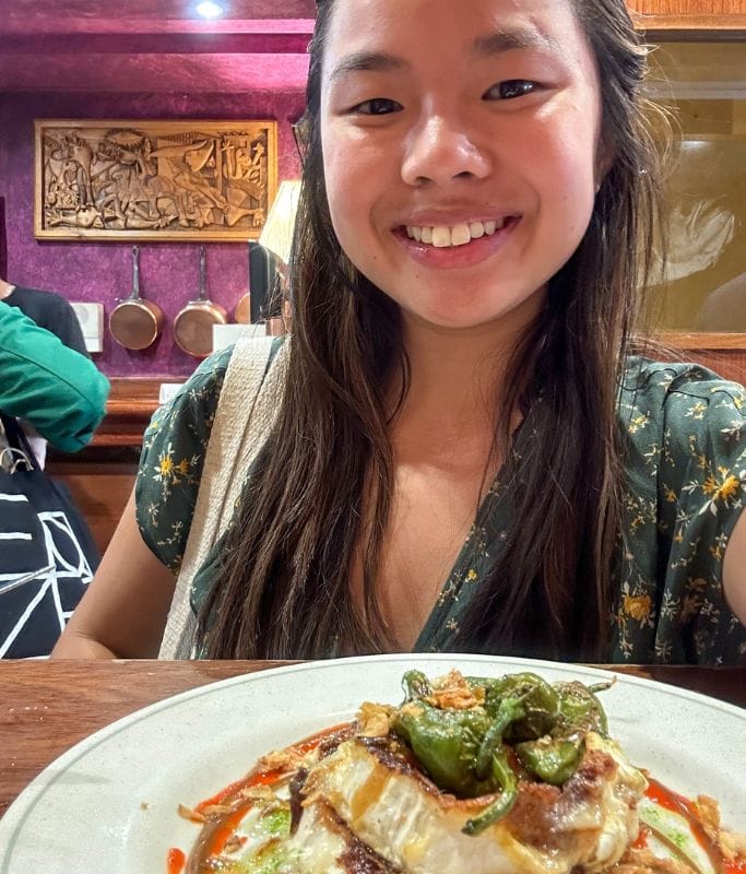 A picture of Kristin smiling with her food in San Sebastian