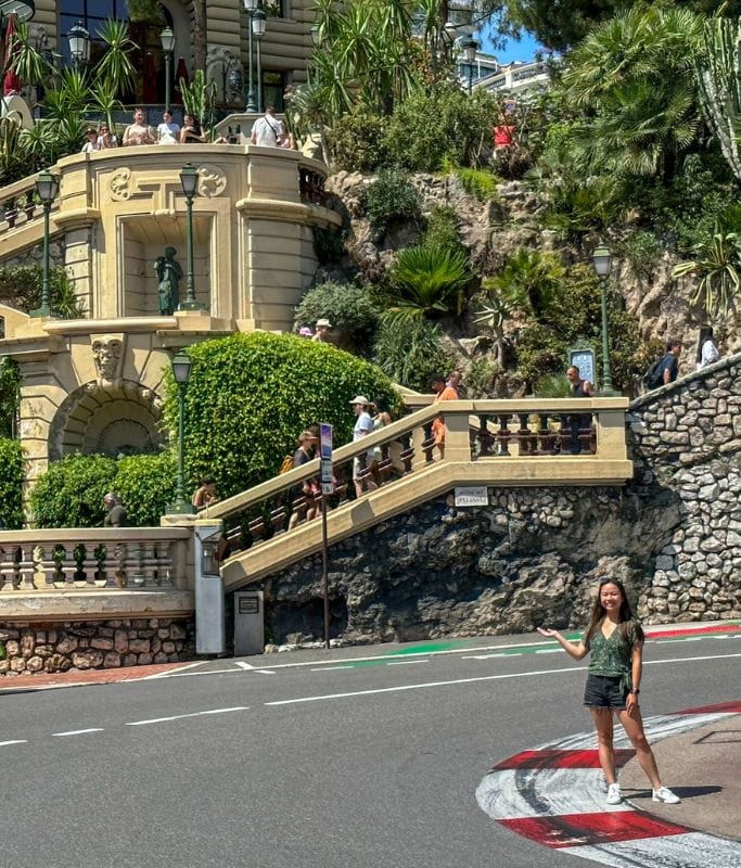 A picture of Kristin standing on the famous Fairmont Hairpin curve. Stopping by here on your Monaco day trip is a must for formula 1 lovers.