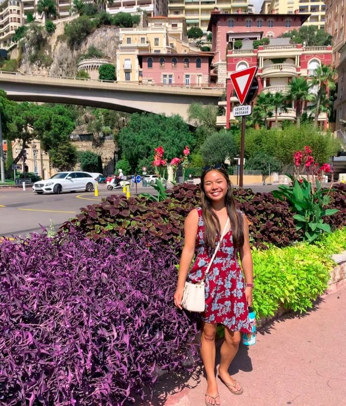 A picture of Kristin standing at a roundabout in Monaco.