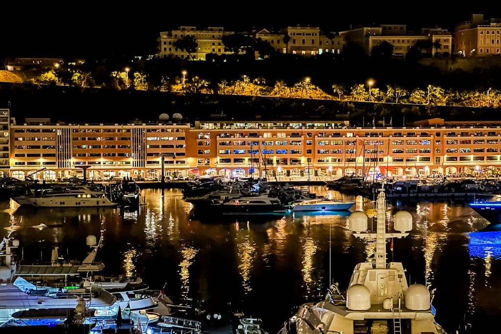 A picture of the yachts in the harbor in Monaco, at night.