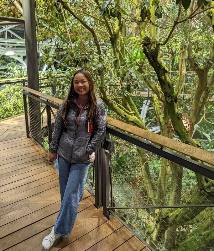 A picture of Kristin standing on one of the boardwalks within the Amazon Spheres.