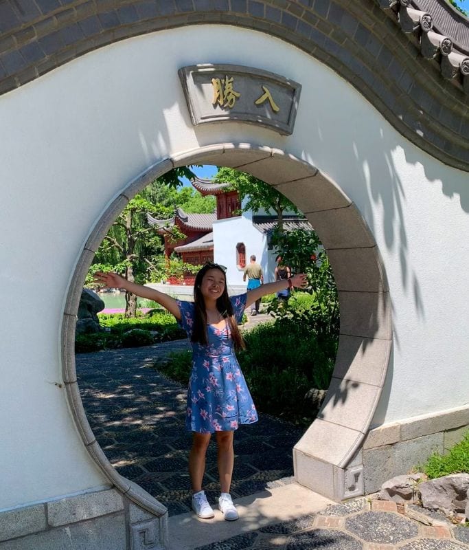 A picture of Kristin standing in an archway at the Kristin at the Montreal Botanical Gardens.