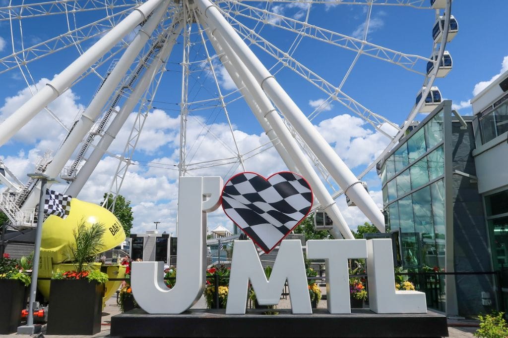 A picture of Montreal's Old Port, ferris wheel, and some of the decorations they have during race weekend for the Canadian Grand Prix.