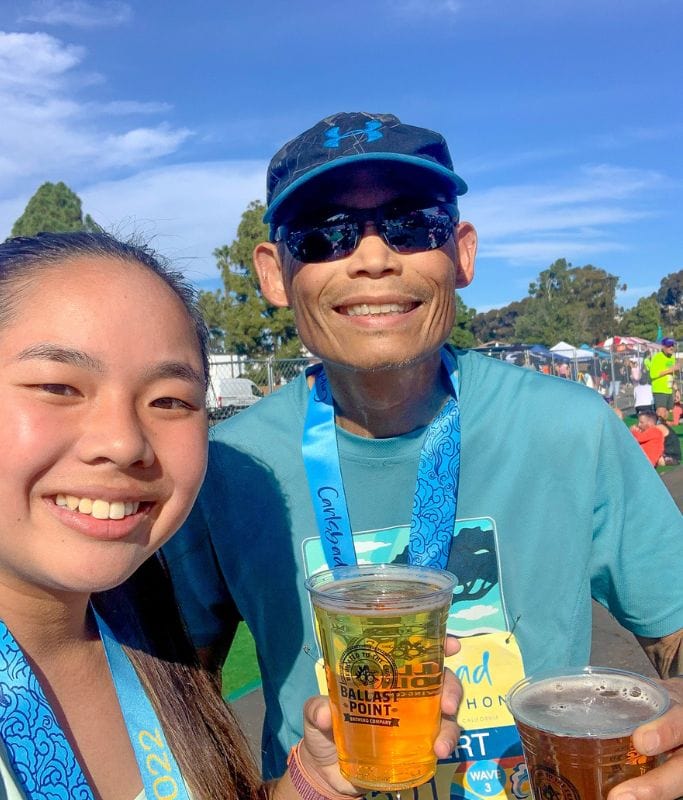 A picture of Kristin and her dad drinking some beer post running the Carlsbad race.