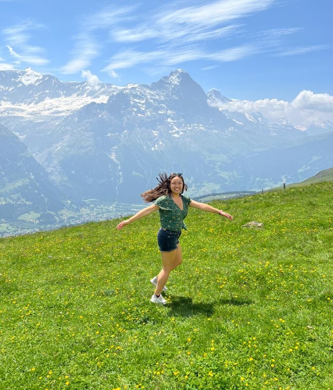 A picture of Kristin twirling in the grass at Grindelwald First.