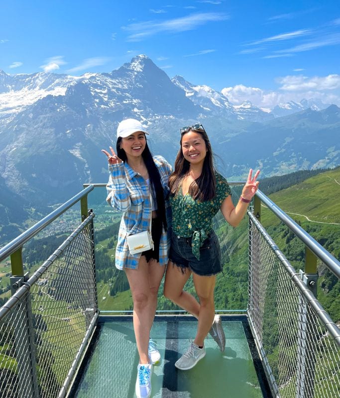 A picture of Kristin and her friend posing on the terrace that stretches out from First summit.