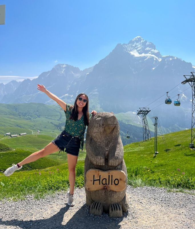 A picture of Kristin posing with a wooden marmut.